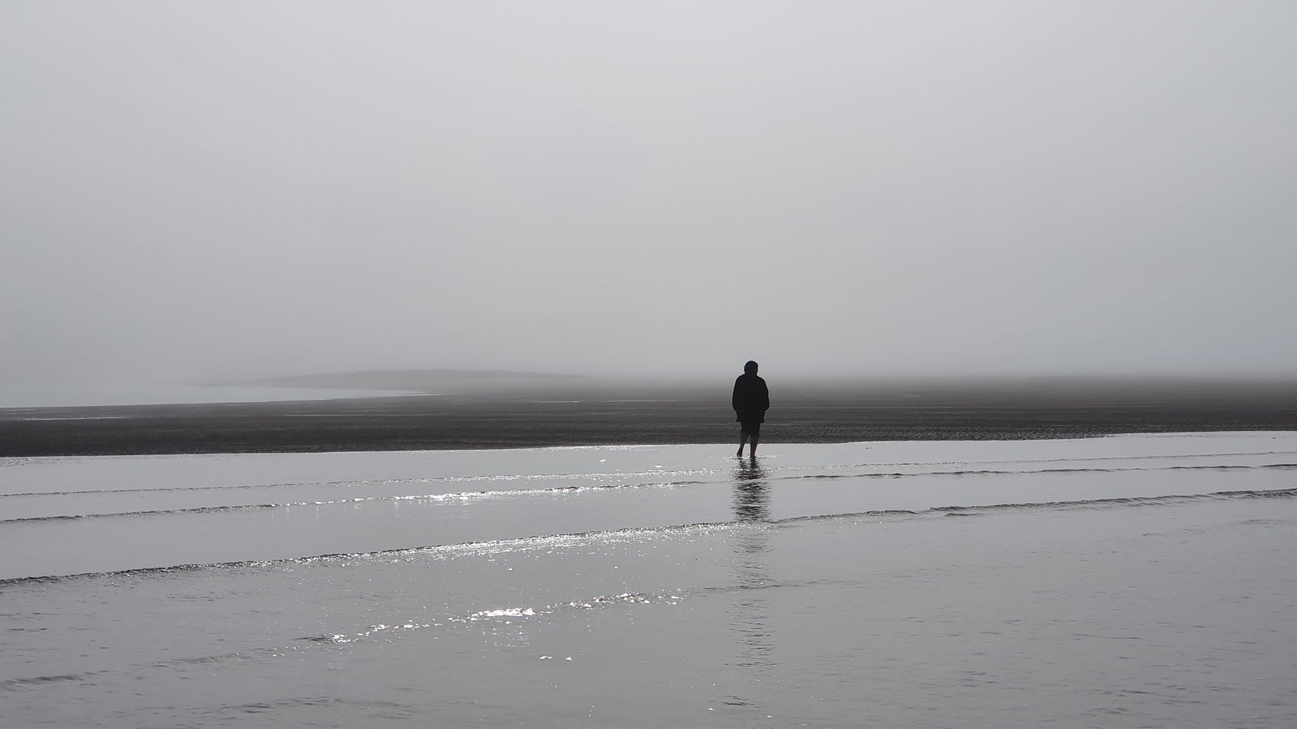 Clarice walking in the fog on Brandon Bay
