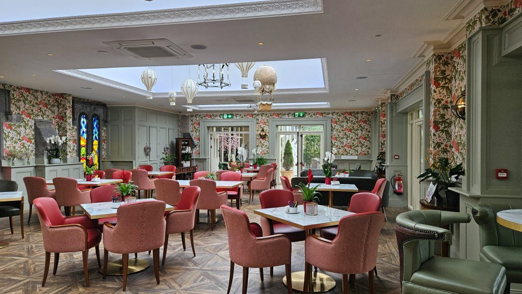 The beautiful orangery is filled with light and comfortable tables and chairs.